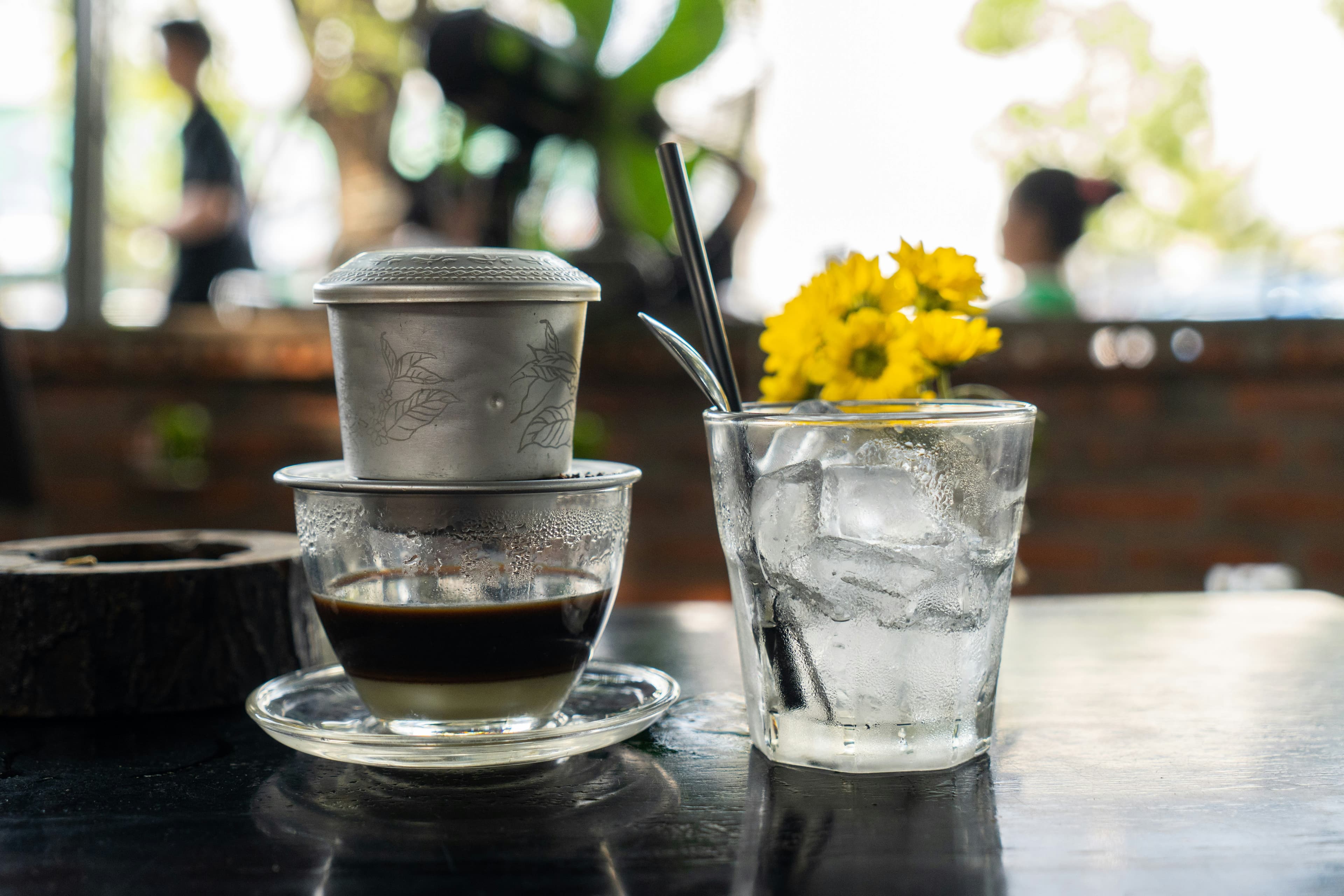 Vietnamese coffee dripping through a phin filter